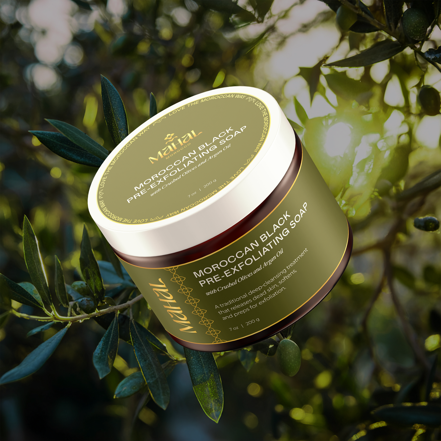 Jar of Moroccan Black Pre-Exfoliating Soap with olive leaves in the background