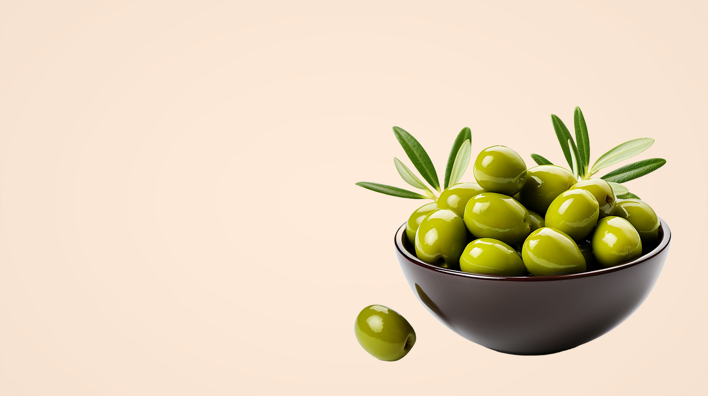 Bowl of green olives with a sprig on a beige background