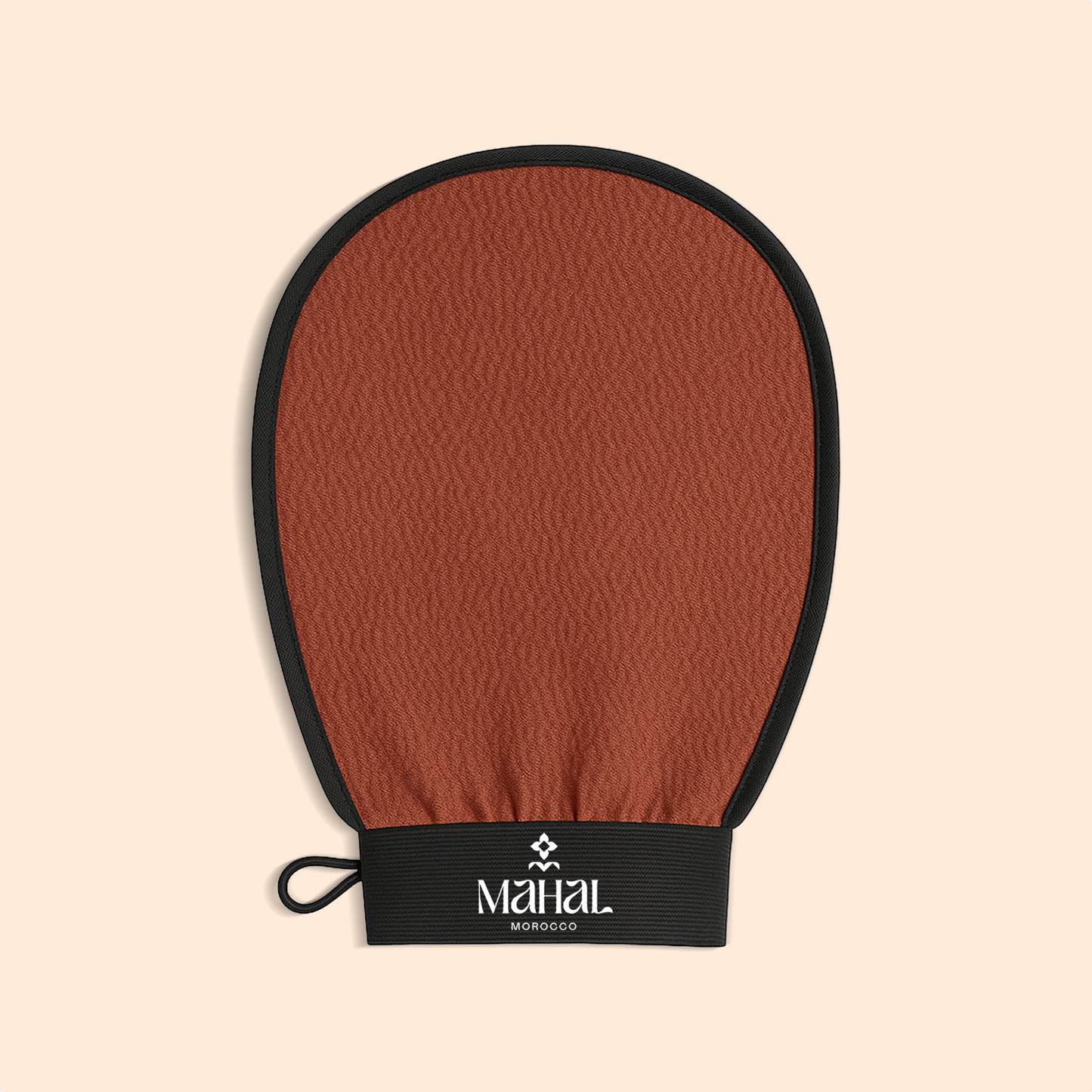 Brown exfoliating glove with black wrist strap on a beige background, featuring the 'Mahal' brand