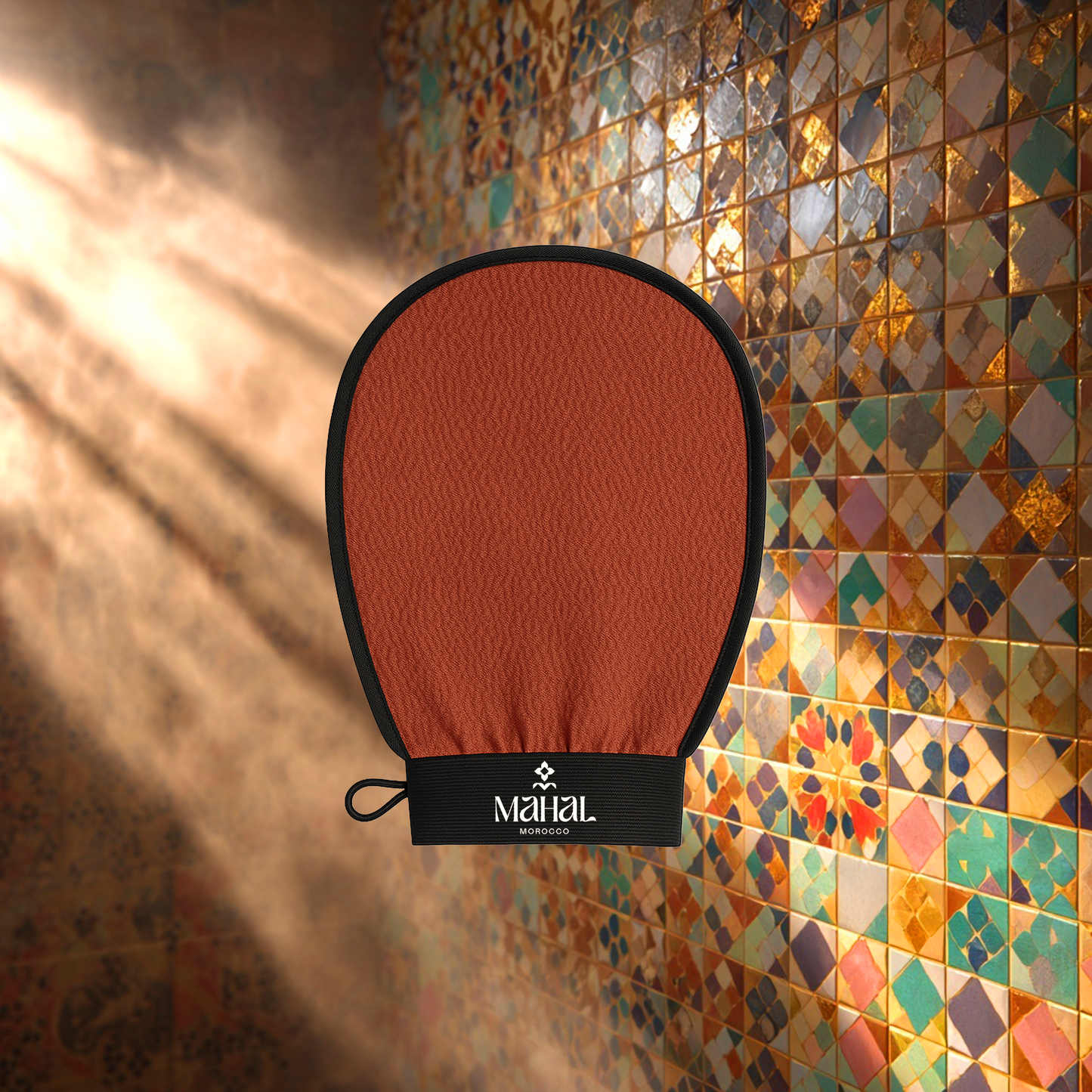 Brown exfoliating glove with black cuff against a colorful tiled wall