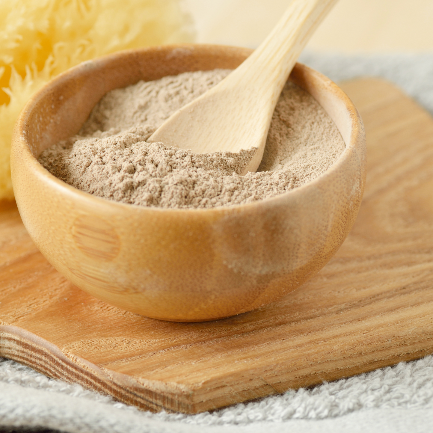 Rhassoul clay powder in wooden bowl