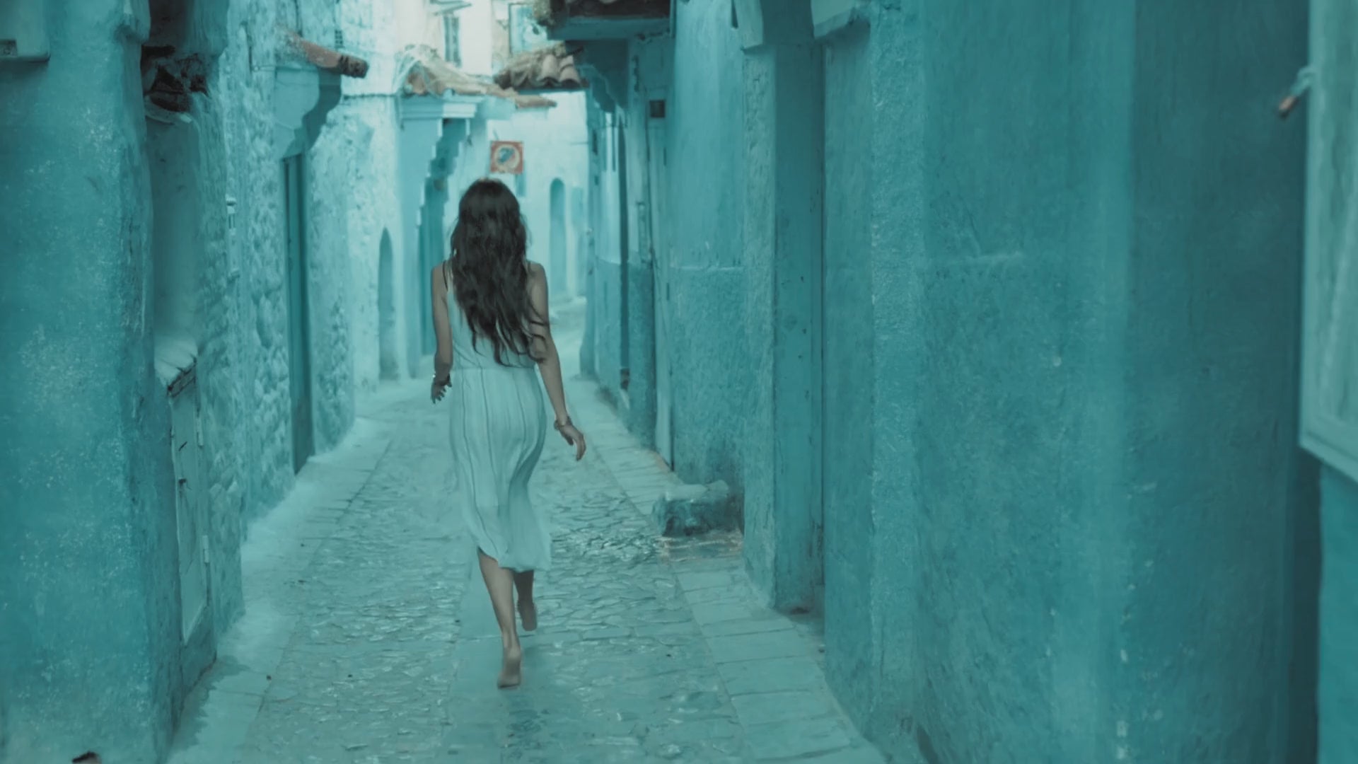 Slow motion of young woman gracefully strolling the streets of Moroccan city